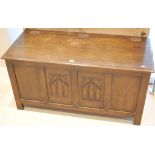 An early 20th century moulded oak four panelled hinge top blanket box,