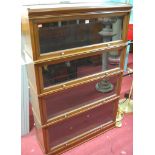 A 1930s walnut Globe Wernicke style four tier stacking bookcase, having hinged glazed doors, w.86.