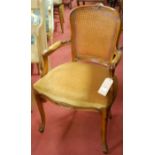 A 19th century mahogany ladderback single elbow chair;