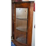 A reproduction mahogany serpentine front freestanding corner cupboard,