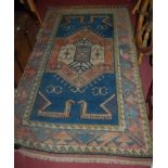 A Turkish blue ground woollen rug, having stylised geometric field within trailing borders,