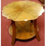 A 1930s figured walnut and crossbanded shaped top two tier occasional table