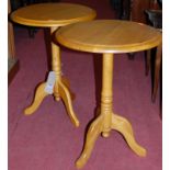 A pair of modern rubberwood circular fixed pedestal occasional tables