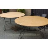 A pair of wrought iron and plywood topped patio tables of good size, dia.