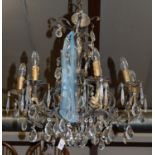 A pair of floral cast wrought metal eight light hanging electroliers,