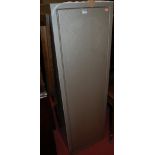 A contemporary steel freestanding single door gun cabinet, with keys, w.