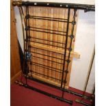 A Victorian style black painted wrought iron and brass kingsize bedstead, having slatted pine base,