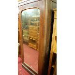 A Victorian mahogany single mirror door round cornered wardrobe (formerly centre section from a