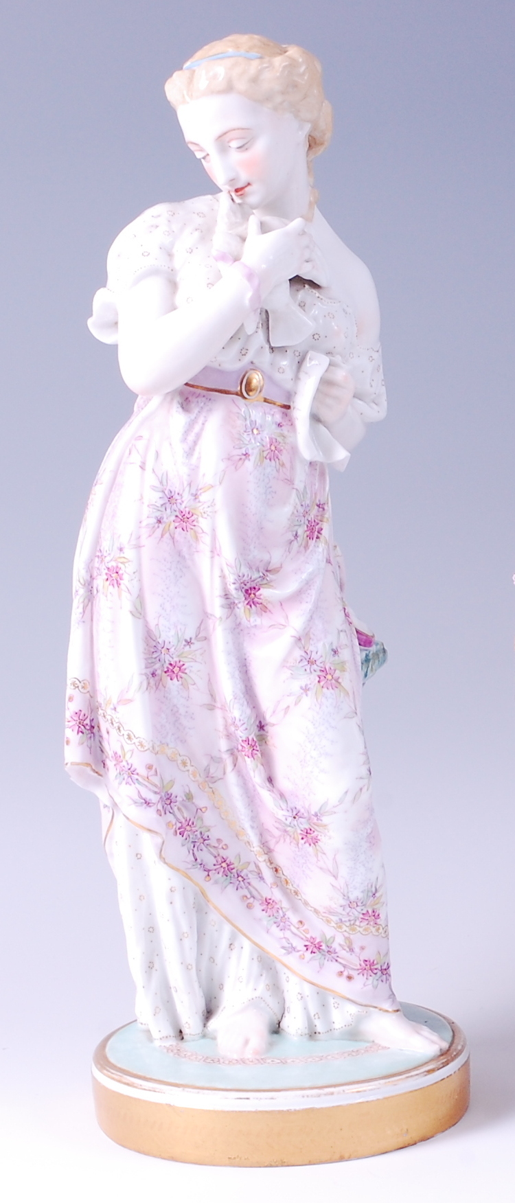 A circa 1900 Meissen Dresden porcelain figurine, of a maiden cradling a dove,