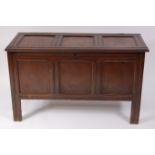 An early 19th century joined oak coffer, having three panel lid on split-pin hinges,