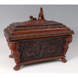 A Victorian carved walnut tea caddy, of carved sarcophagus form and good size,