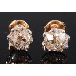 A pair of 18ct gold diamond ear studs, the claw set old cut diamonds each weighing approx 1.