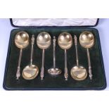 A cased set of six Victorian silver gilt apostle tablespoons, with sifting spoon,