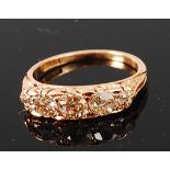 An 18ct gold and diamond five stone ring, the graduated old brilliants in a chased setting,