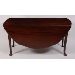 *A George III mahogany padfoot dining table, the oval fall leaves on gatelegs, w.141cm, h.71cm, d.