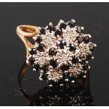 A modern 9ct gold, sapphire and diamond cluster ring, arranged as a tiered flower head,