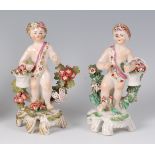 A pair of Bow porcelain figures of putti, each holding a basket of flowers, circa 1760,