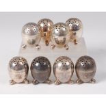 A set of eight Mappin & Webb silver pepperettes, each of egg shape, having star pierced covers,