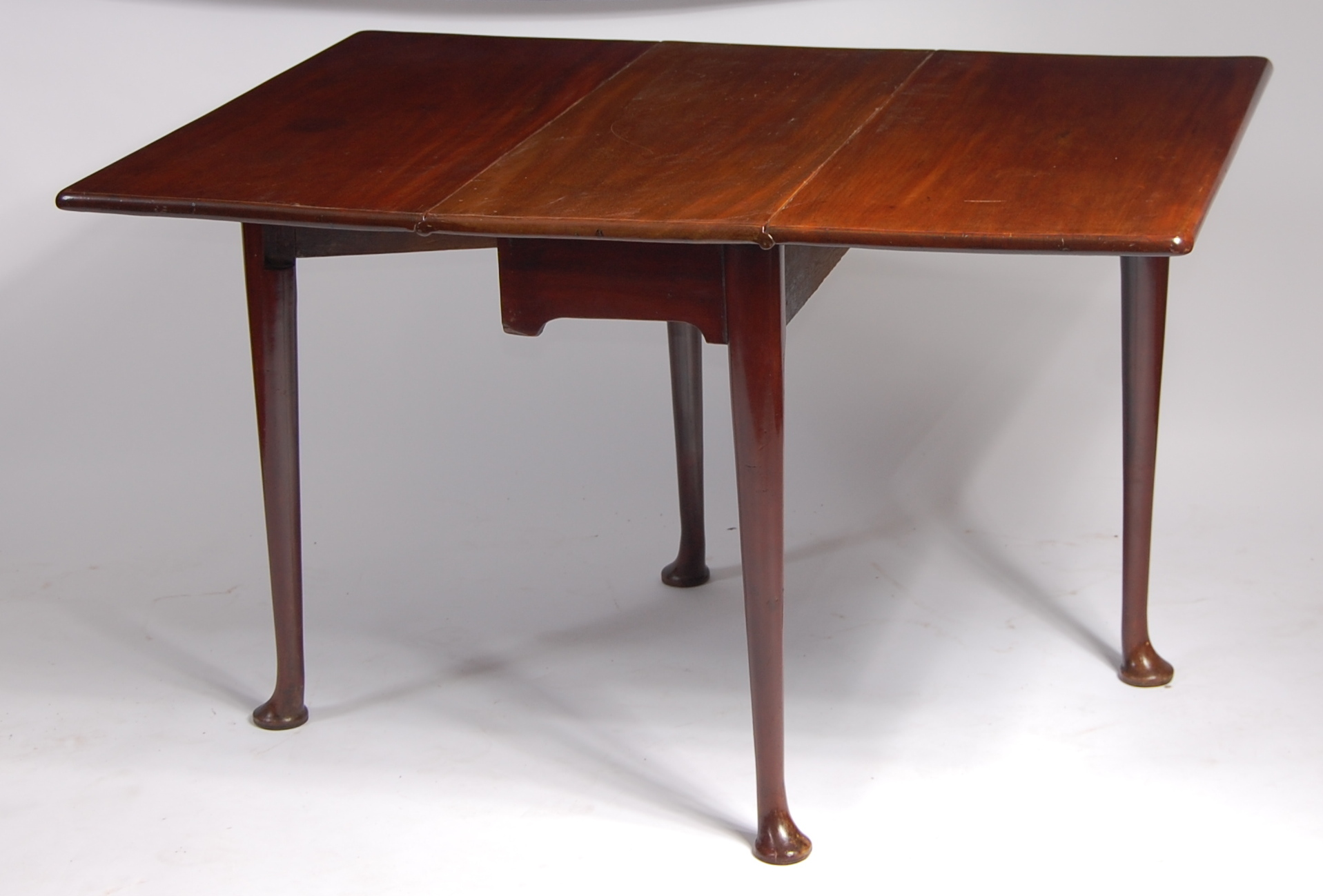 *A George III mahogany padfoot dining table, having square fall leaves on turned gatelegs, w.