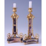 A pair of George III ormolu mounted blue-john candlesticks, in the manner of Matthew Boulton,