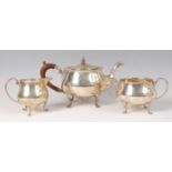 A George V silver bachelors three piece tea set, comprising; teapot, twin handled sugar and cream,