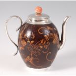 An 18th century lacquered and polished coconut shell teapot, with white metal mounts and handle,