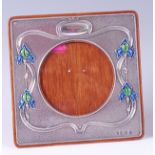 An Art Nouveau silver and embossed easel photograph frame, later enamelled in soft greens and blues,