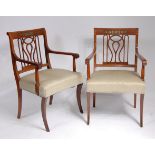 A pair of mahogany elbow chairs, in the French Empire style,
