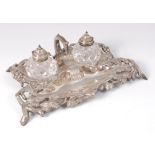 A mid-Victorian silver inkstand, having a centre carry handle issuing fruiting vines,