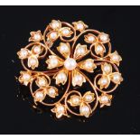 An early 20th century 18ct gold and seed pearl set openwork flower head pendant, 5.6g, dia.