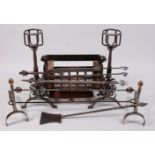 *A Victorian Gothic Revival steel and wrought iron fire set,