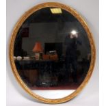 A 19th century giltwood and gesso wall mirror, the oval plate in a moulded surround,