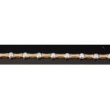 An 18ct gold diamond set bracelet, arranged as sixteen waisted links,