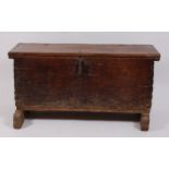 An 18th century provincial oak six plank coffer, having loop hinges and exposed dovetail joints,