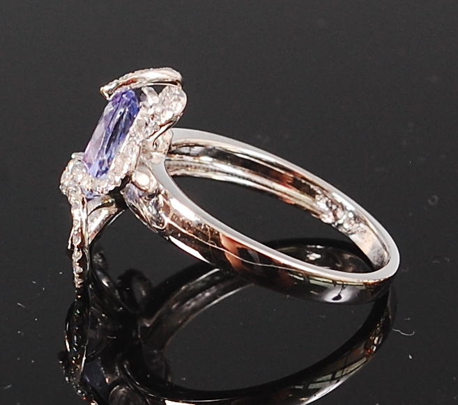 A contemporary 14ct white gold and diamond ring, set with an oval cut tanzanite weighing approx 1. - Image 2 of 2