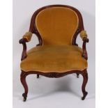 A mid-19th century mahogany framed and upholstered armchair, having swept back and arms,