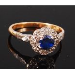 An 18ct gold, sapphire and diamond cluster ring, the four claw set sapphire weighing 0.
