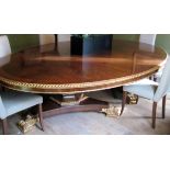 An Arthur Brett mahogany and giltwood twin pedestal dining table, of massive proportions,