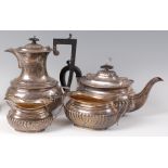 A circa 1900 silver harlequin four piece tea and coffee set, comprising; teapot, coffee pot,
