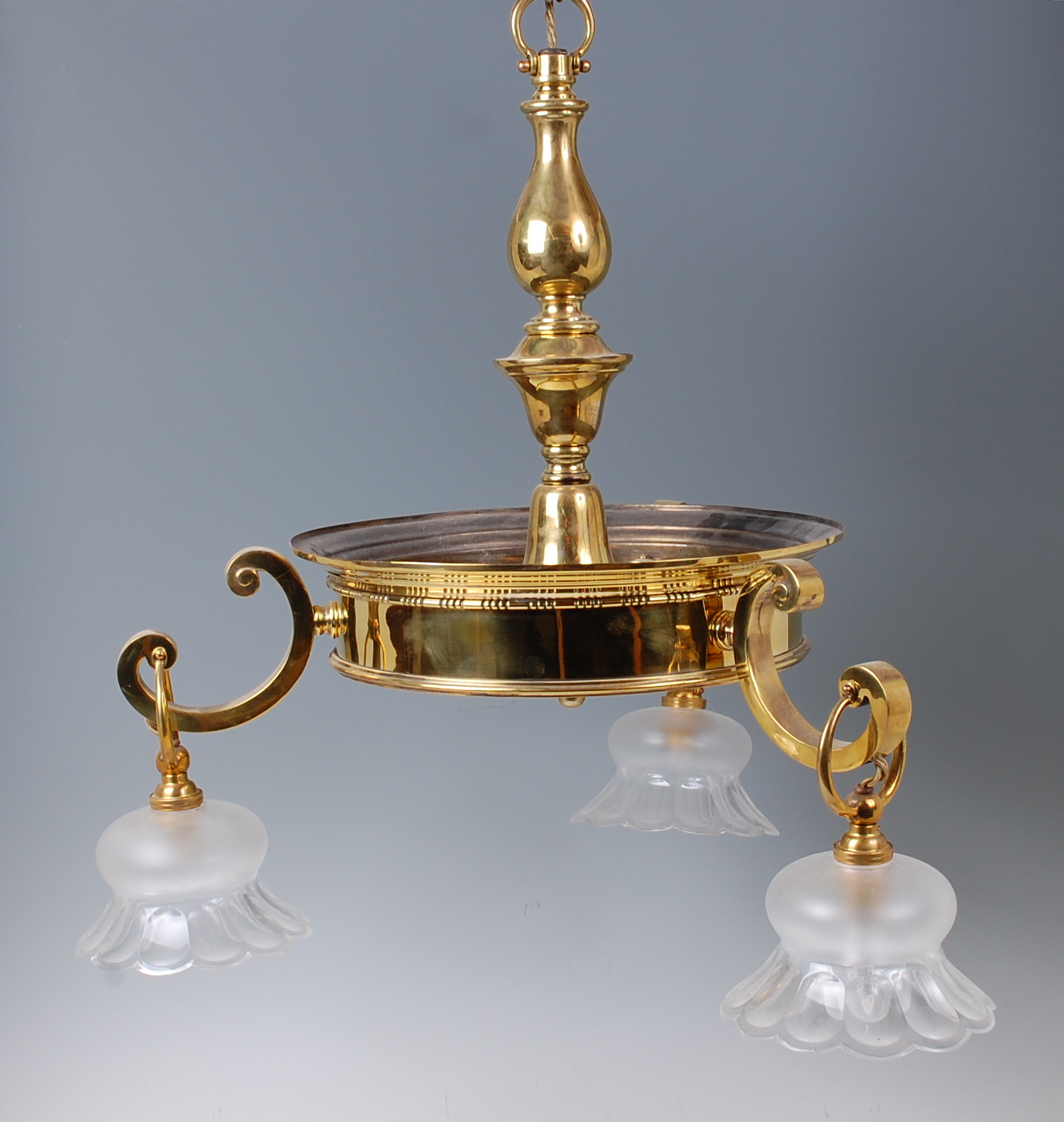 An early 20th century lacquered brass three light ceiling pendant,