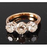 An 18ct gold and diamond three stone ring, the centre claw set brilliant weighing approx 0.