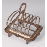 A Mappin & Webb silver six division toast rack, having centre carry handle and on scroll feet, 14oz,