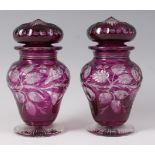 A pair of Stevens & Williams purple overlay glass jars and covers, each of shouldered baluster form,