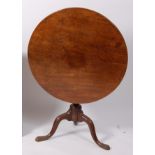 A George III mahogany pedestal tripod table, having a circular tilt-top on birdcage action,
