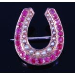 A late Victorian 14ct gold, seed pearl and ruby set brooch, in the form of a horseshoe,