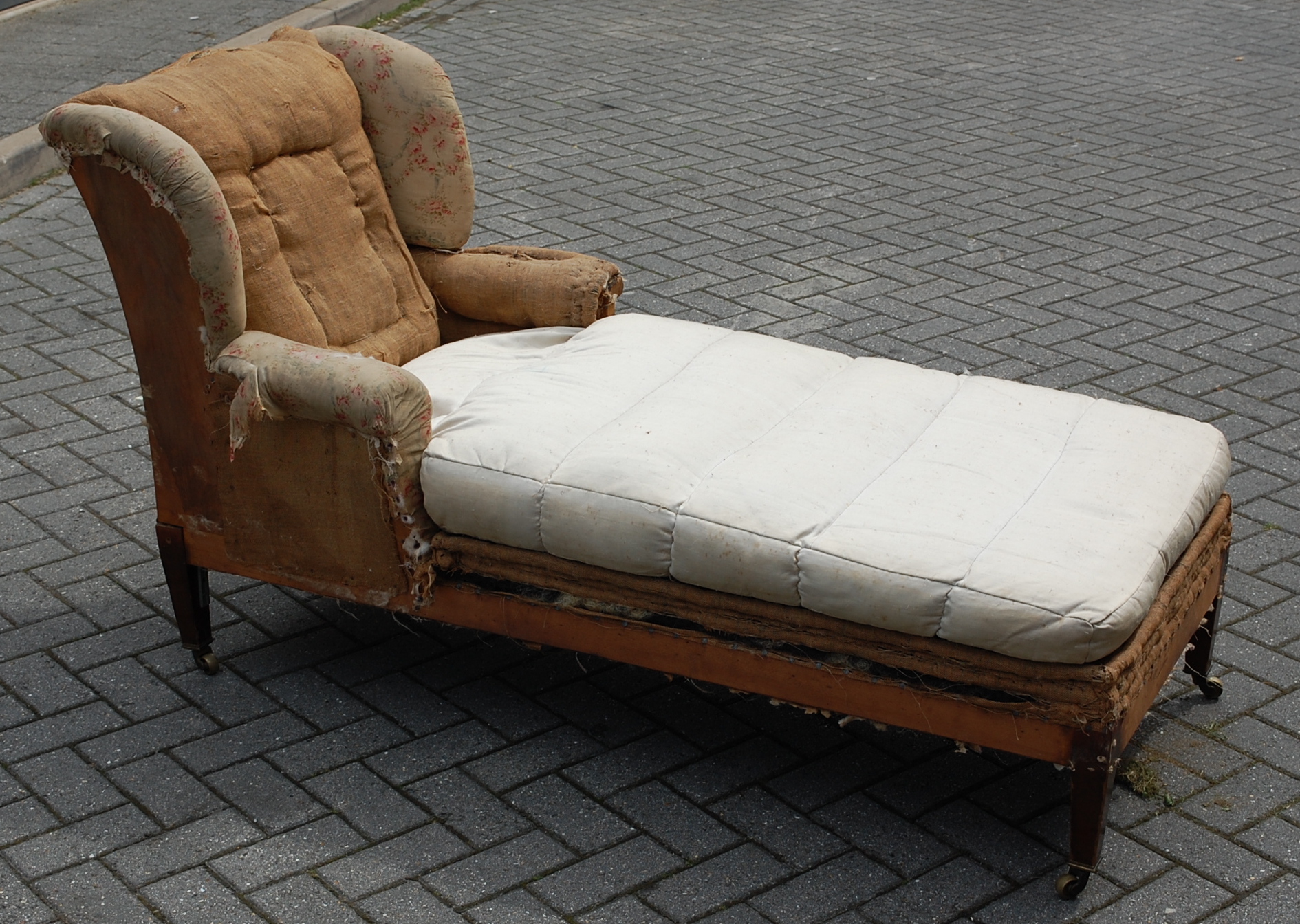 A late Victorian wingback day-bed by Howard & Sons, partly floral upholstered,