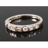 A platinum and diamond set half eternity ring, arranged as alternating brilliant cut diamonds,