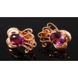 A pair of 18ct gold amethyst set ear clips, the oval cut amethyst with pierced five scroll surmount,
