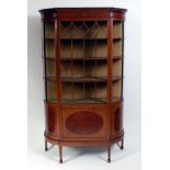 A circa 1900 fiddleback mahogany and inlaid china display cabinet, having a breakfront, bowed sides,