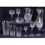 An Edwardian part suite of cut glassware, comprising; claret jug, two water jugs,